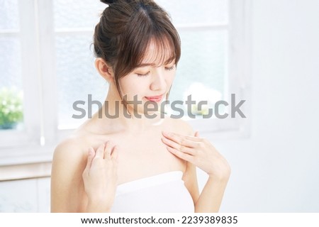 Asian woman taking care of her chest