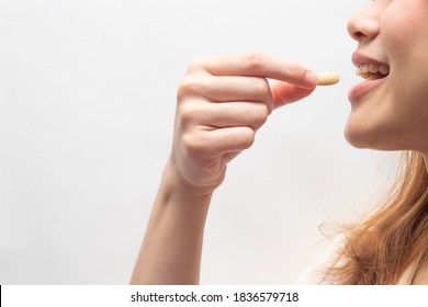 Asian Woman Taking And Eating Vitamin And Medicine. Vitamin D,E,A Fish Oil Capsule, Nutrition. 