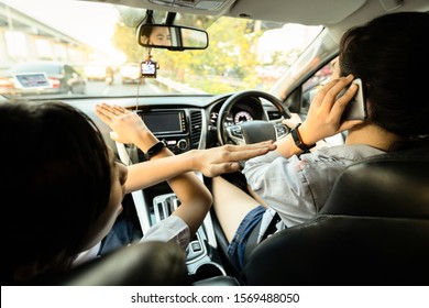 Asian Woman Talking On A Cell Phone While Driving Car,female Driver Losing Concentration,dangerous Driving,daughter Is Telling Her Mom To Stop, Prohibited Using Mobile Phone,illegal,transport Concept