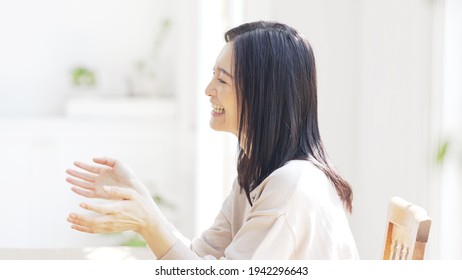 Asian woman talking in the room. - Powered by Shutterstock