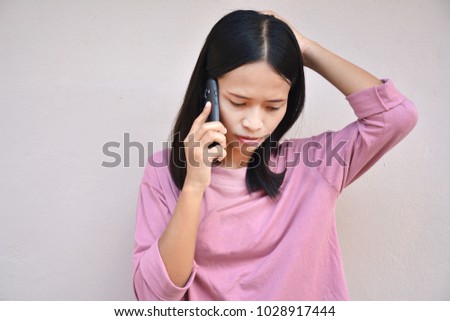 Asian woman talking  a smart phone.