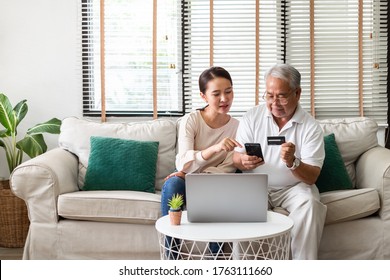 Asian Woman Teach Senior Use Credit Card And Phone For Online Shopping