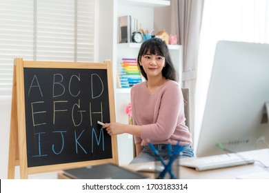 Asian Woman Teacher Teaching English Alphabet Via Video Conference E-learning To Elementary School Student, Homeschooling And Distance Learning ,online ,education And Internet.
