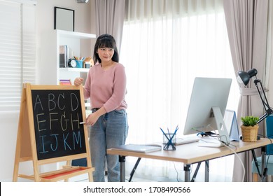 Asian Woman Teacher Teaching English Alphabet Via Video Conference E-learning To Elementary School Student, Homeschooling And Distance Learning ,online ,education And Internet.