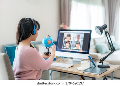 Asian woman teacher teaching geography via video conference e-learning and cheerful elementary school student looking at globe, Homeschooling and distance learning ,online ,education and internet. - Shutterstock ID 1704620137