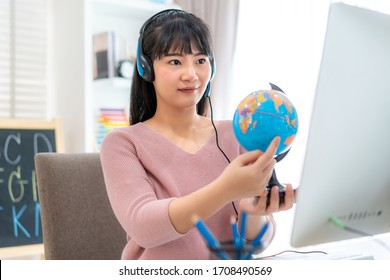 Asian woman teacher teaching geography via video conference e-learning and cheerful elementary school student looking at globe, Homeschooling and distance learning ,online ,education and internet.