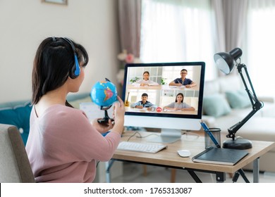 Asian woman teacher teaching geography via video conference e-learning and cheerful elementary school student looking at globe, Homeschooling and distance learning ,online ,education and internet.