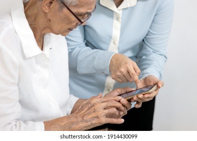 Asian Woman Teaching The Old People How To Use Mobile Phone,senior Grandmother Learning To Use Smartphone With A Help Of Adult Daughter,learn Electronic Gadget,study Modern Technology For Elderly