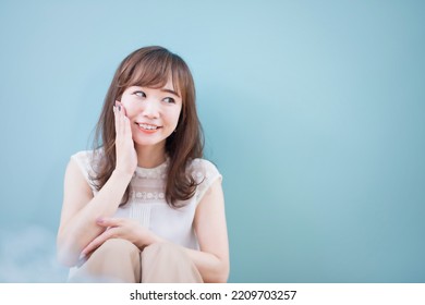 Asian Woman Touching Her Cheek