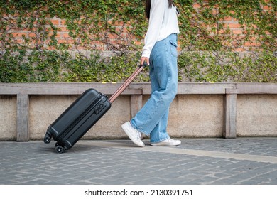 Asian Woman Tourist Is Going To Holiday Trip And Walking To Dragging With Black Luggage To Passengers Lounge In The Airport