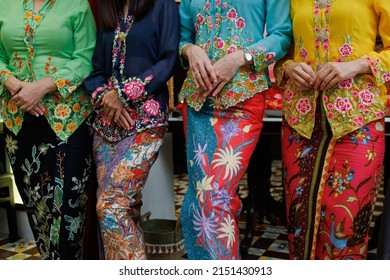 Asian woman in traditional Malay Batik Kebaya or Baba Nyonya dress close up.