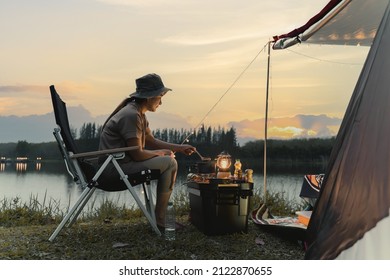 Asian woman travel and camping alone at natural park in Thailand. Recreation and journey outdoor activity lifestyle. - Shutterstock ID 2122870655
