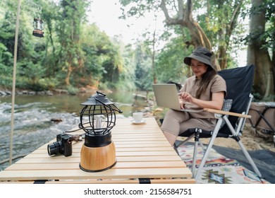 Asian Woman Travel And Camping Alone. Businesswoman Online Working And Relaxing During Journey Outdoor Activity.