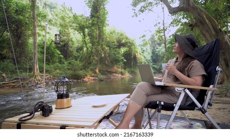 Asian Woman Travel And Camping Alone. Businesswoman Online Working And Relaxing During Journey Outdoor Activity.