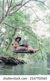 Asian Woman Travel And Camping Alone. Businesswoman Online Working And Relaxing During Journey Outdoor Activity.