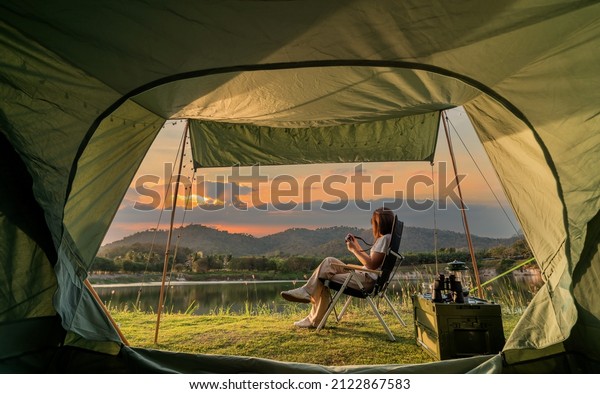 Asian
woman travel and camping alone at natural park in Thailand.
Recreation and journey outdoor activity
lifestyle.