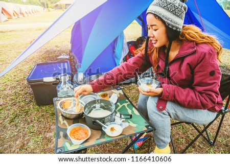Asian woman travel relax in the holiday. camping on the Mountain. sit eat breakfast. Thailand