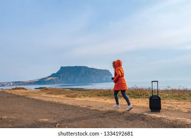 Asian Woman Travel At Seongsan Ilchulbong In Jeju Island,South Korea