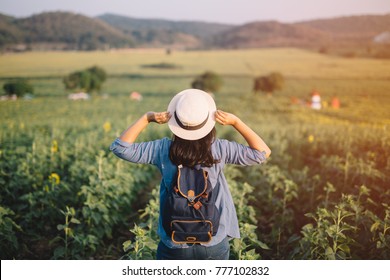 Asian Woman Traveler With Backpack Holding Hat And Looking At Amazing Mountains And Forest, Travel Holiday Relaxation Concept.