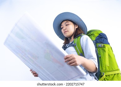 Asian Woman Traveling With Backpack And Bucket Hat Ready To Travel With Map In White Studio