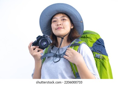 Asian Woman Traveling With Backpack And Bucket Hat Ready To Travel With Camera In White Studio