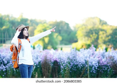 Asian Woman Traveling, Resting, Flower Garden, Relaxing Happily Freshen Up On Vacation