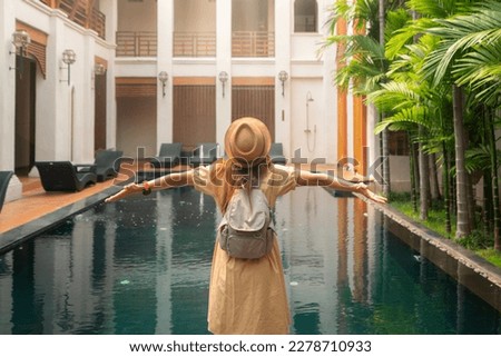 Asian woman traveller relax in resort and swimming pool in Hotel in Chiangmai, Thailand