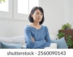 Asian woman in trouble in the living room