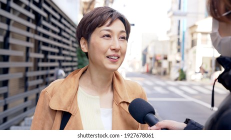 Asian Woman Undergoing A Street Interview.