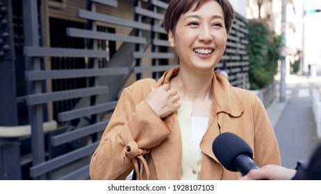 Asian Woman Undergoing A Street Interview.