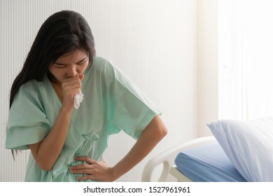 Asian Woman, Unhappy Patient Suffering From  High Fever And Chronic Cough In The Hospital. 