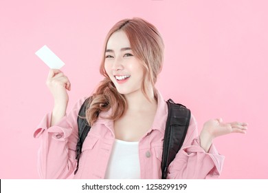 Asian woman use blank credit card for travel with pink background