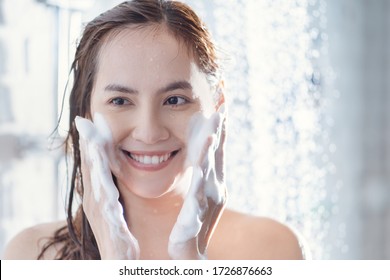Asian woman use foam to wash your face after showering.