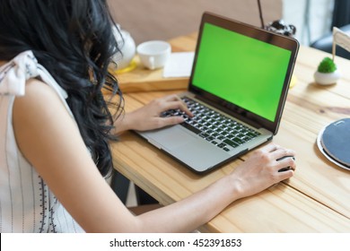 Asian Woman Use Laptop Computer, Green Screen, Selective Focus Too Soft.