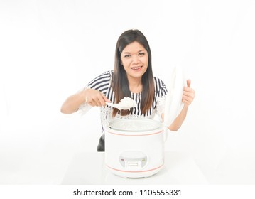 Asian Woman Use A Rice Cooker Cook For Meal In The Kitchen