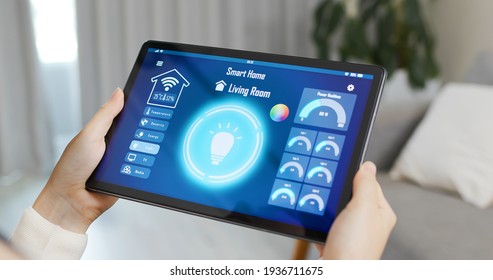 Asian Woman Use Smart Home App To Turn On The Light With Tablet Pc