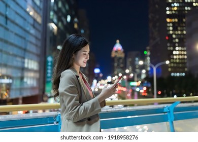 asian woman use smartphone outdoor while commuting