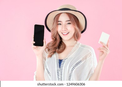 Asian woman use smartphone to payment online shopping with blank credit card, summer holiday, pink background