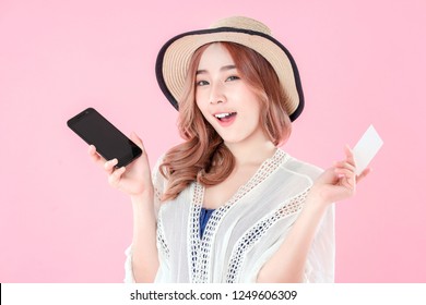 Asian woman use smartphone to payment online shopping with blank credit card, summer holiday, pink background