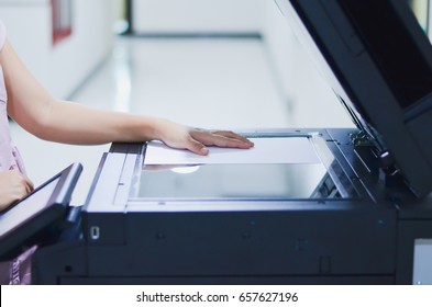 Asian Woman  Using Copy Machine  In The Office