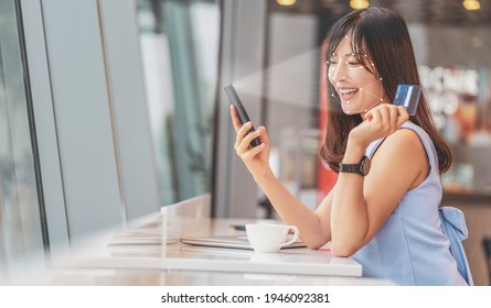 Asian woman using face recognition via smart mobile phone indoors, Biometric Verification and artificial intelligence, online shopping and payment online concept