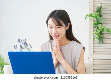 Asian woman using the laptop
 at home
