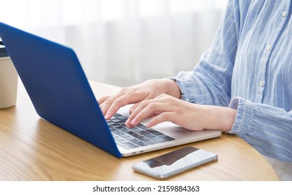 Asian Woman Using The Laptop At Home, No Face