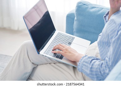 Asian Woman Using The Laptop At Home, No Face