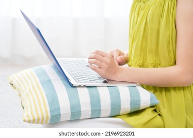 Asian Woman Using The Laptop At Home, No Face