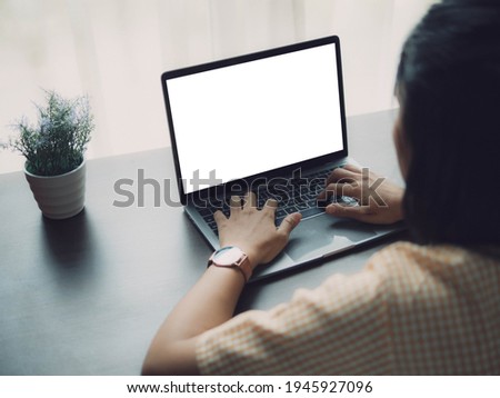 Asian woman using laptop and smartphone at home. Young asian business woman talking smart phone and working with labtop .Work at home concept.