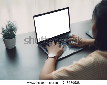 Asian woman using laptop and smartphone at home. Young asian business woman talking smart phone and working with labtop .Work at home concept.
