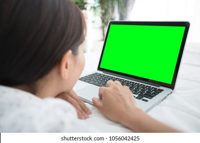 Asian Woman Using Laptop, Workplace At Home With Green Screen. Concept Of Asian Woman Lifestyle.