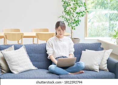 Asian Woman Using The PC  At Home