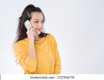 Asian Woman Using Phone Call Wearing A Yellow Sweater Isolated On White Background.